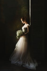 Woman in wedding dress holding bouquet